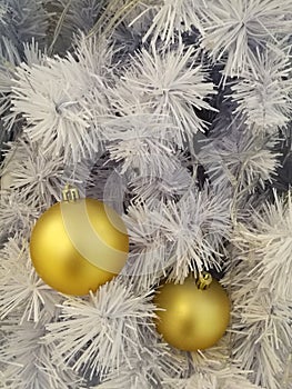 White Christmas tree decoration golden ball ornaments with white tinsel background