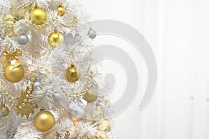 White christmas tree with gold decoration on white background