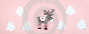 white christmas tree made of paper and deer on pink paper background