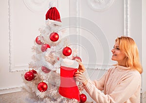 White christmas tree red balls. Christmas stockings. Home Christmas atmosphere. Winter holidays and people concept.