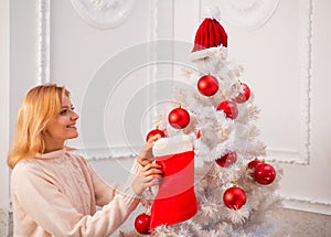 White christmas tree red balls. Christmas stockings. Home Christmas atmosphere. Winter holidays and people concept.