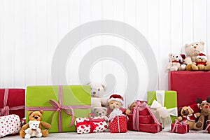 White christmas wooden background with teddy bears and presents