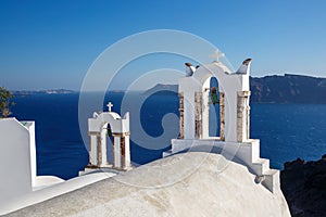 White church bell with blue sea background, Greece, Santorini island.