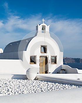 White church with a bell tower. Photo taken in Santorini island, Greece