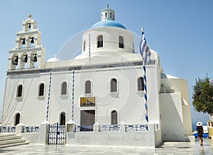 White Church with bells and blue dome at Oia, Santorini, Greek Islands