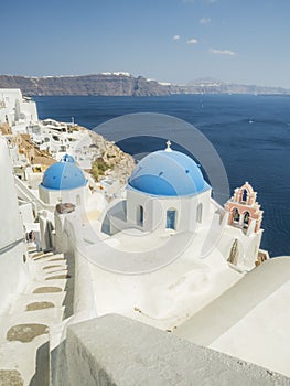 White Church with bells and blue dome at Oia, Santorini, Greek Islands