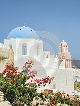 White Church with bells and blue dome at Oia, Santorini, Greek Islands