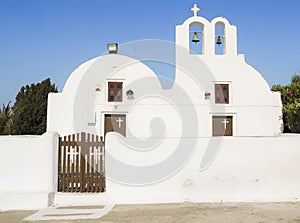 White Church with bells and blue dome at Oia, Santorini, Greek Islands