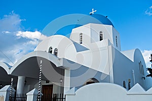 White church with blue dome at Oia village, Santorini island