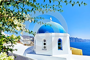 White church with blue roof on santorini