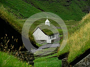 White Church with grass roof in the village of Saksun on the Streymoy Island