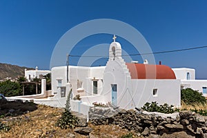 White church with red roof in town of Ano Mera, Mykonos island, Greece