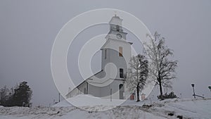 Boda church in winter mist in Dalarna, Sweden photo