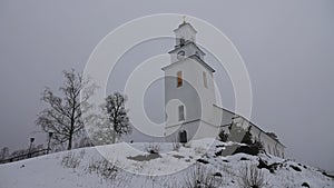 Boda church in winter mist in Dalarna, Sweden photo
