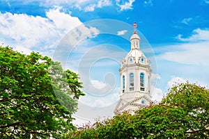 White church spire on blue cloudy background