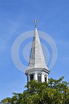 White pointed church steeple and cross in Concord, Middlesex county, Massachusetts, United States. New England Architecture, USA