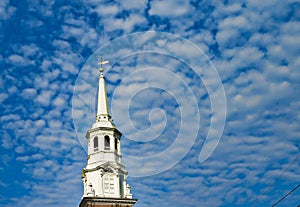 White church steeple set against a blue sky.