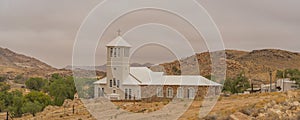 White Church from Town Aus, Namibia, background cloudy sky