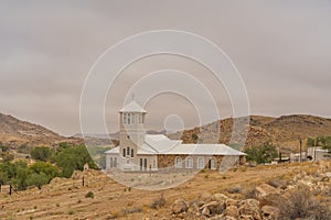 White Church from Town Aus, Namibia, background cloudy sky