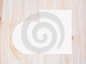 White circle paper and blank white paper on vintage brown wooden background.