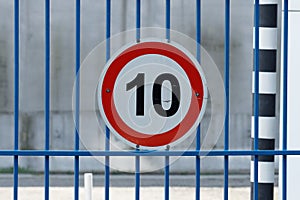 white circle road sign with red border and number ten. speed limit 10 kilometers per hour