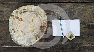 A white circle of wood was placed on a wooden table