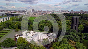 White circus tent in park in front of Parliament. Calm aerial view flight berlin