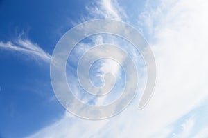 White cirro-cumulus clouds in soft blue sky photo