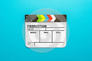 White clapperboard as filmmaking concept on turquoise blue background copy space
