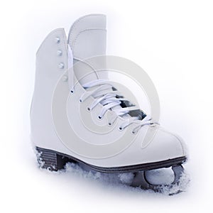 White classical iceskate shoe partially covered in snow