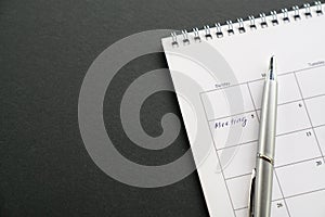 White clean calendar on black background with copy space. Words. meeting written on a date. Business meeting and schedule concept