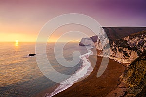White cliffs and beach of the Jurassic Coast of South England during sunset