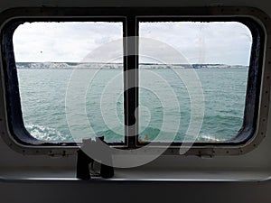 White Cliffs of Dover through grungy ship`s window