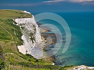 The white cliffs of Dover in Kent, UK. Taken on a calm day in summer, with a clear, turquoise sea
