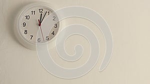 White clock hanging on wall ticking, full HD