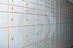 White closed lockers of various sizes on wall