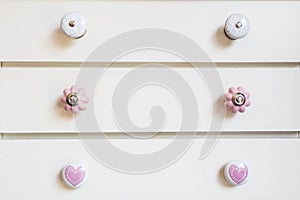 White closet doors with colorful knobs