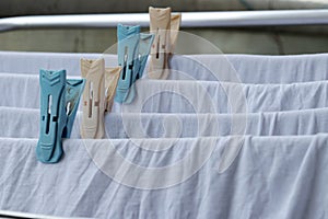 White clothes drying on standing clotheshores with clothespins white inner wear on Rack dryer Collapsible clothes horse with