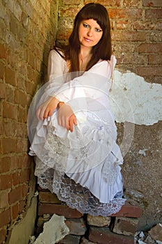 White clothes on a young girl on brick wall background