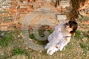 White clothes on a young girl on brick wall background