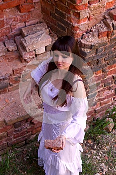 White clothes on a young girl on brick wall background