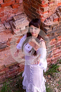 White clothes on a young girl on brick wall background