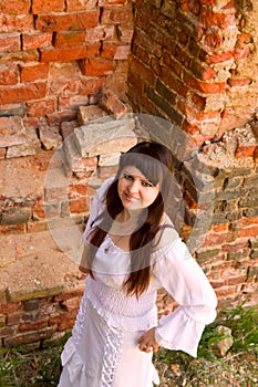 White clothes on a young girl on brick wall background