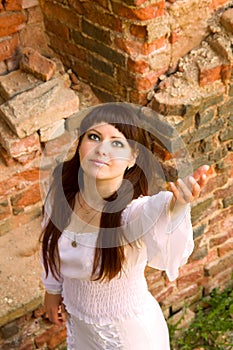 White clothes on a young girl on brick wall background