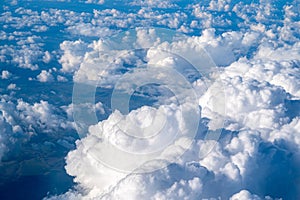 white cloud clusters seen from above from an airplane