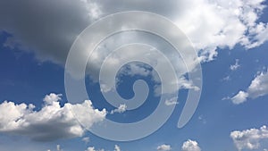 White cloud disappear in the hot sun on blue sky. Cumulus clouds form against a brilliant blue sky. Time-lapse motion clouds blue