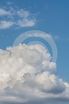 White cloud formations on the blue sky. Abstract heaven background with white clouds