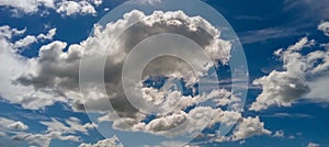 White clouds with a blue glossy sky.