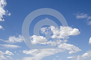 White clouds on a blue sky. Background