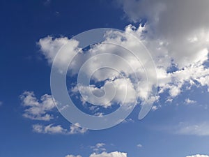 White clouds on a blue sky. Background